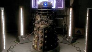 Imprisoned and helpless, the Dalek is tortured.